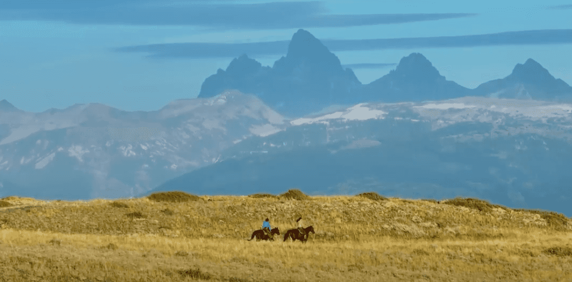 Riding horses in Teton Valley, Idaho under the shadow of the Teton Mountain Range.